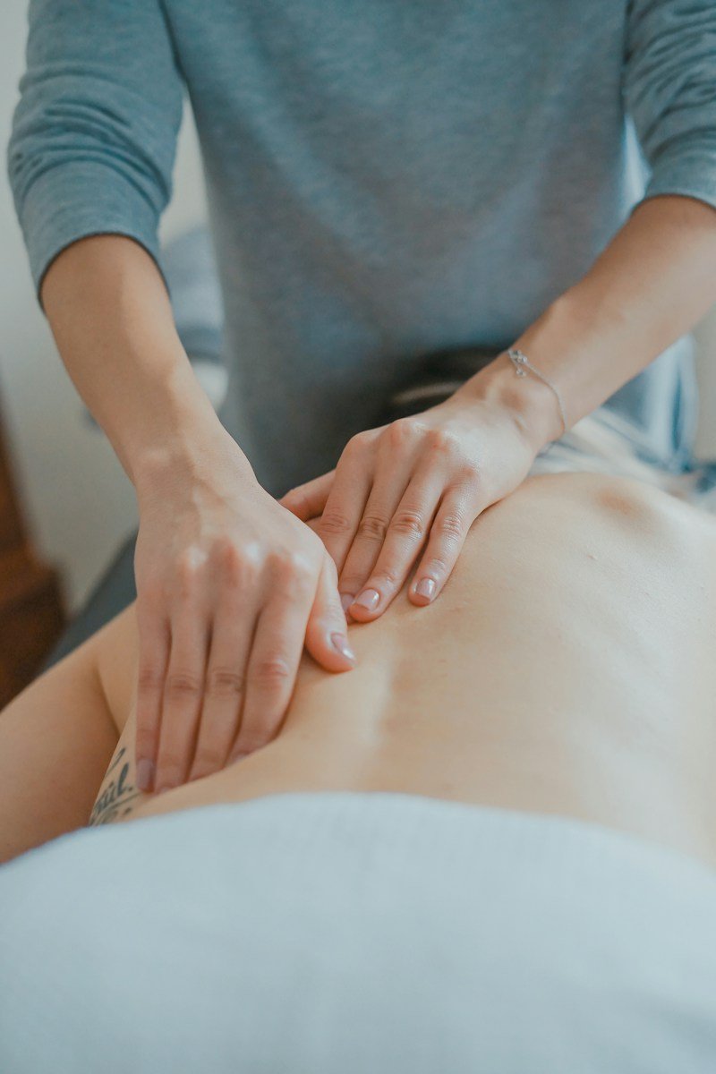 Massage therapy session detail with clean towels and relaxing oils